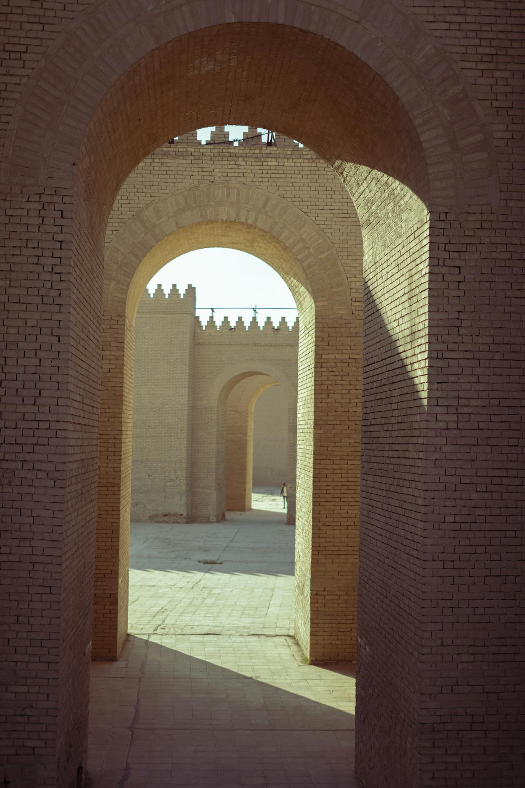 A stunning view through ancient brick arches in Baghdad, Iraq, highlighting historical architecture.