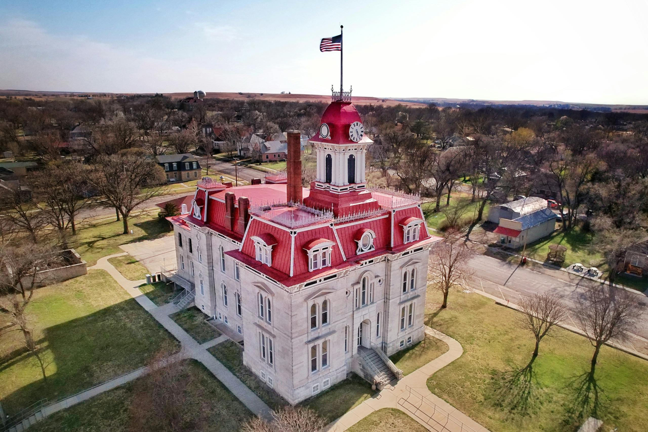 Aerial shot of the historic Chase County Courthouse in Cottonwood Falls, KS, capturing its distinctive architecture.